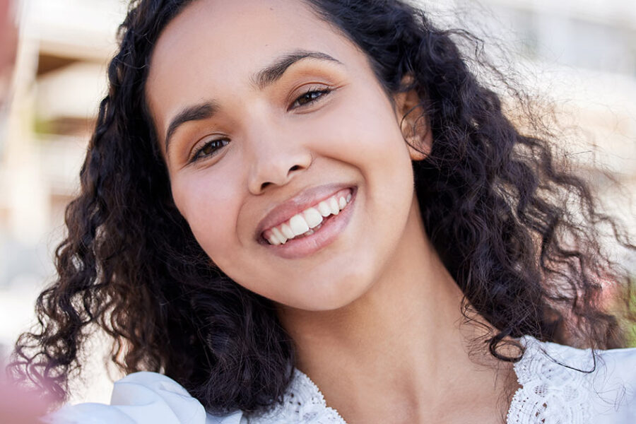 woman with invisalign smiling at camera