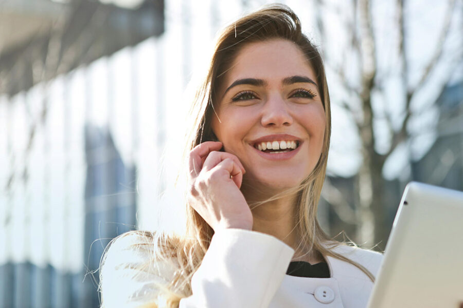 A woman smiling after learning how to close a tooth gap