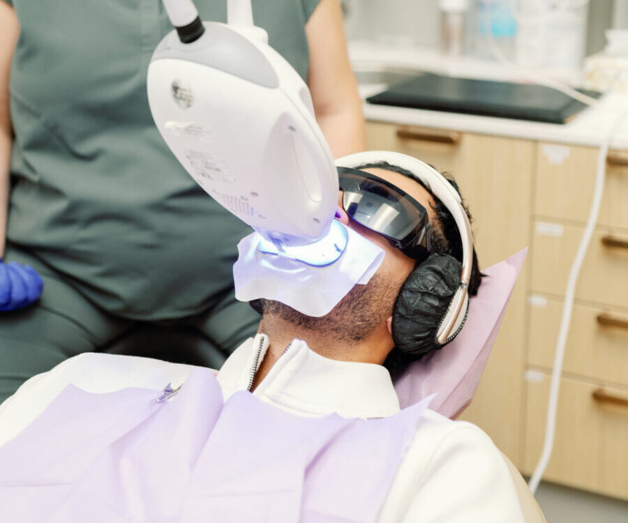 A patient undergoing Zoom Teeth Whitening in Vancouver at Nest Dental