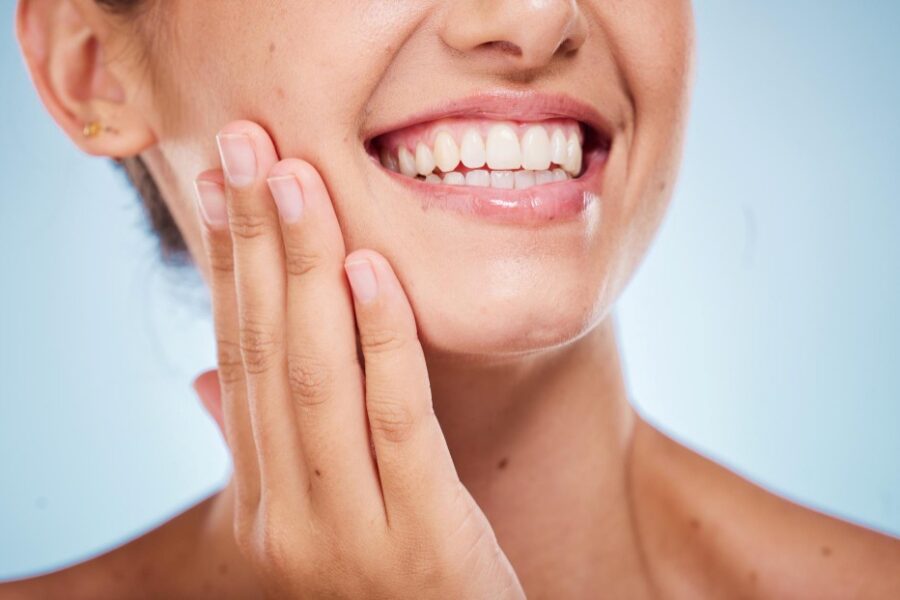 A close up of a woman's smile for a blog post titled, "Can Invisalign Fix an Underbite?"